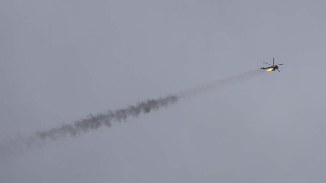 Syrian government helicopter is shot by a missile in Idlib province, Syria, Tuesday, Feb. 11, 2020. Syrian rebels shot down a government helicopter Tuesday in the country's northwest where Syrian troops are on the offensive in the last rebel stronghold. (AP Photo/Ghaith Alsayed)