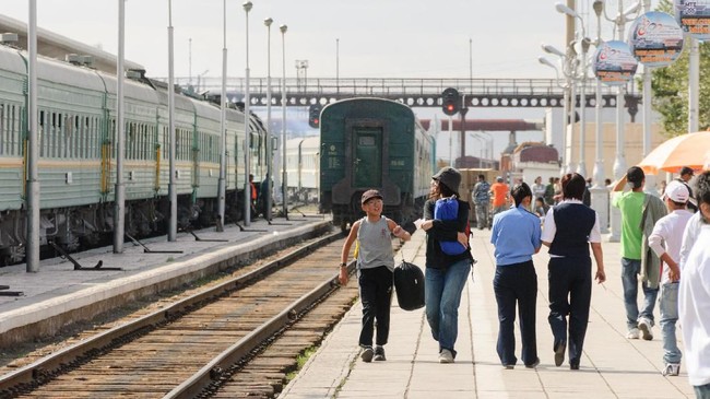 UlaanBaatar, Mongolia - August 31, 2006: The people who got off the train are walking a platform to the ticket gate.