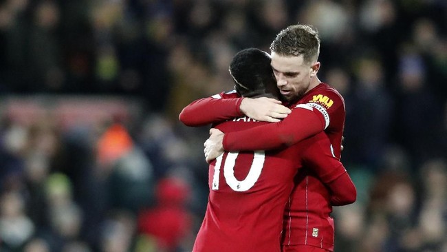 Liverpool's Sadio Mane, left, and Liverpool's Jordan Henderson celebrate at the end of the English Premier League soccer match between Norwich City and Liverpool at Carrow Road Stadium in Norwich, England, Saturday, Feb. 15, 2020. (AP Photo/Frank Augstein)
