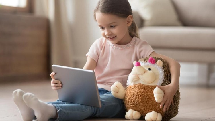Cute little child watch movie on smartphone at bed. Dangers of blue light can damage eyes. Handsome little boy can be age related macular degeneration from blue light, wear eyeglasses since childhood