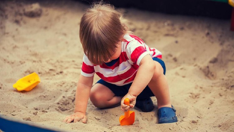 Little boy playing in sandbox