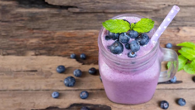 1003875404 Blueberry smoothies juice beverage healthy the taste yummy In glass drink episode morning on wooden background.