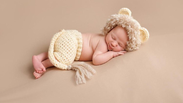 One Month Old Baby Boy Sleeping, wearing a crochet lion cub costume