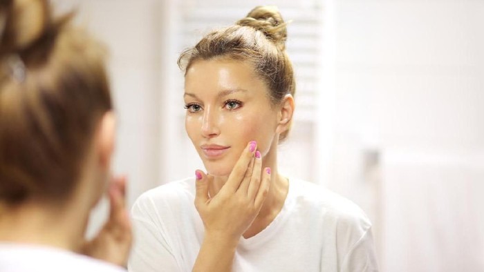 Magic anti-aging cream.Applying the cream
