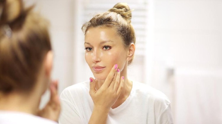 Magic anti-aging cream.Applying the cream
