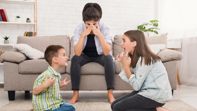 Problems of motherhood. Mom is depressed by screaming children, siblings having quarrel