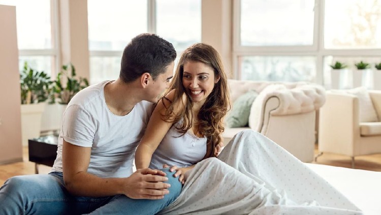 Suami dan istri Young loving couple enjoying in their morning time and talking to each other in bedroom.
