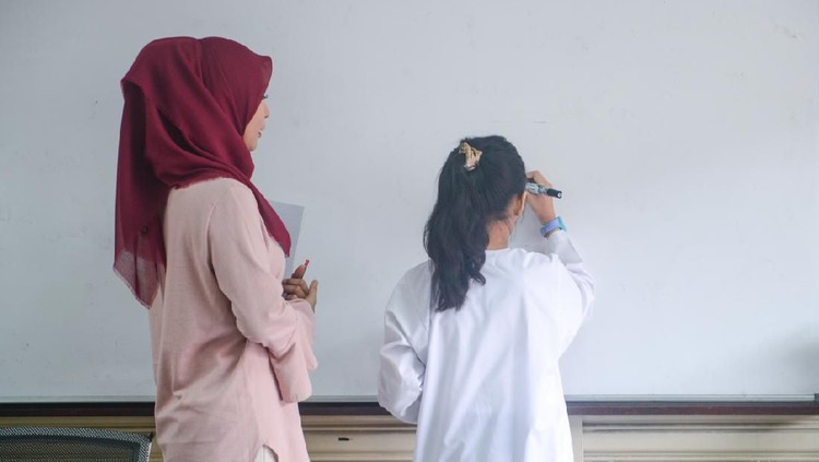 Wanita yang diduga wali murid menyuruh guru untuk merangkak mengelilingi kelas. Kabarnya, ia melakukan hal tersebut karena tak terima anaknya dihukum oleh guru.