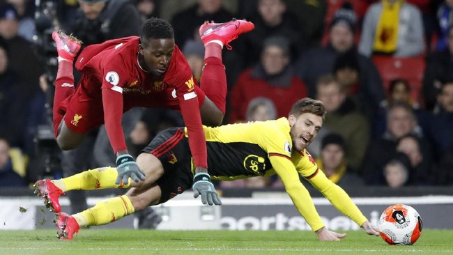 Liverpool's Divock Origi, left, duels for the ball with Watford's Kiko Femenia during the English Premier League soccer match between Watford and Liverpool at Vicarage Road stadium, in Watford, England, Saturday, Feb. 29, 2020. (AP Photo/Alastair Grant)