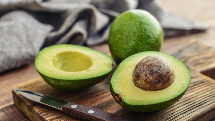 Textured many fresh, organic and green avocado fruits in full-frame background