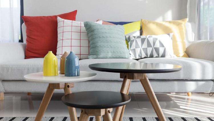 Gray sofa with many colorful pillows on it in livingroom