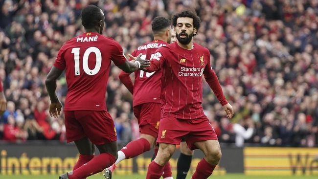 Liverpool's Mohamed Salah, right, celebrates with his teammate Sadio Mane after scoring his side's opening goal during the English Premier League soccer match between Liverpool and Bournemouth at Anfield stadium in Liverpool, England, Saturday, March 7, 2020. (AP Photo/Jon Super)