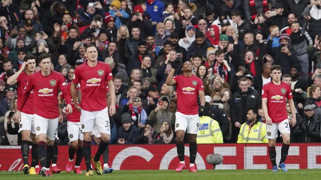 Manchester United's Anthony Martial, second from right, celebrates after scoring the opening goal during the English Premier League soccer match between Manchester United and Manchester City at Old Trafford in Manchester, England, Sunday, March 8, 2020. (AP Photo/Dave Thompson)