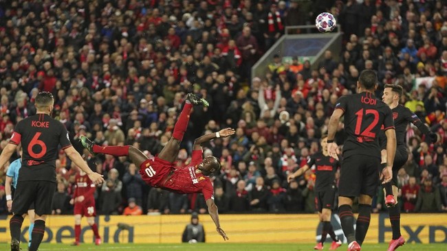 Liverpool's Sadio Mane, center, attempts a shot at goal during a second leg, round of 16, Champions League soccer match between Liverpool and Atletico Madrid at Anfield stadium in Liverpool, England, Wednesday, March 11, 2020. (AP Photo/Jon Super)