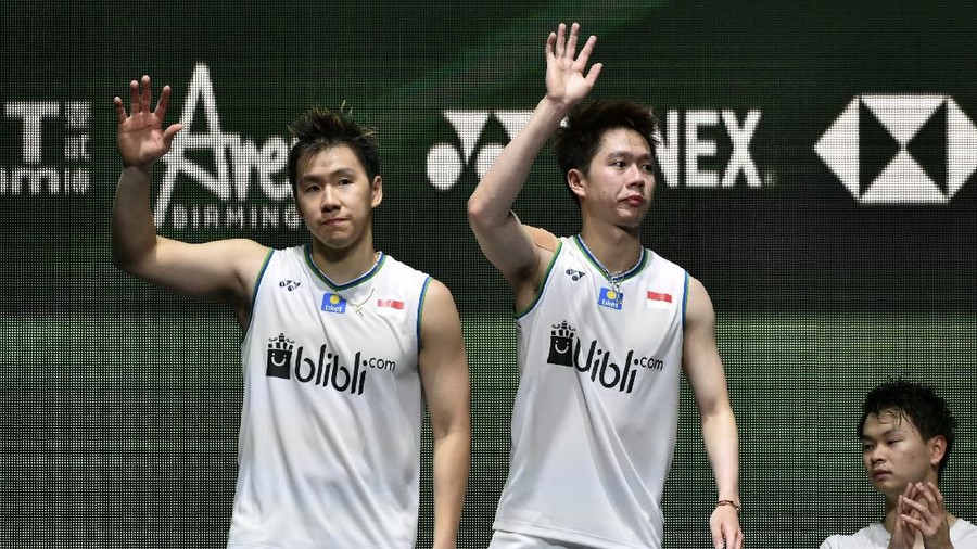 Marcus Fernaldi Gideon, Kevin Sanjaya Sukamuljo Marcus Fernaldi Gideon, left, and Kevin Sanjaya Sukamuljo of Indonesiaand wave from the podium after loosing to Yuta Watanabe and Hiroyuki Endo of Japan in the Men's Doubles final match at the All England Open Badminton tournament in Birmingham, England, Sunday, March 15, 2020. The Japanese team won 2-1. (AP Photo/Rui Vieira)