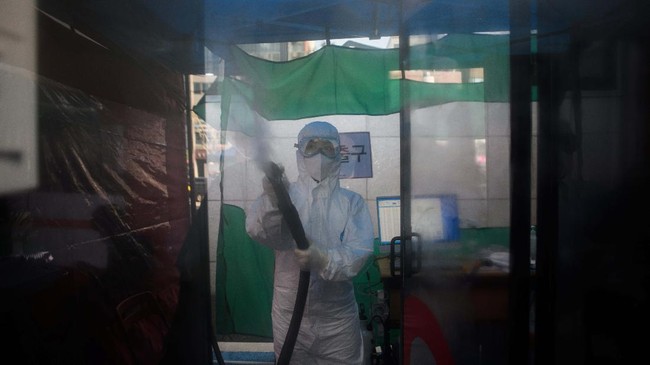 A nurse disinfects a COVID-19 novel coronavirus testing booth outside the Yangji hospital in Seoul on March 17, 2020. - A South Korean hospital has introduced 