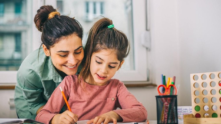 Happy family with kid playing together, caring mom and dad smiling teaching little daughter to draw with color pencils, mother and father having fun with cute child help in creative weekend activity