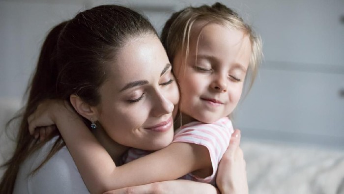 Little cute preschool girl embracing tired, upset mother, single mum with daughter, support, compassion, care, help, say sorry, good relationships of mum and child, motherhood