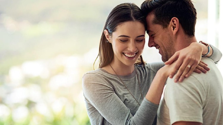 638526574 Shot of a happy young couple in a loving embrace