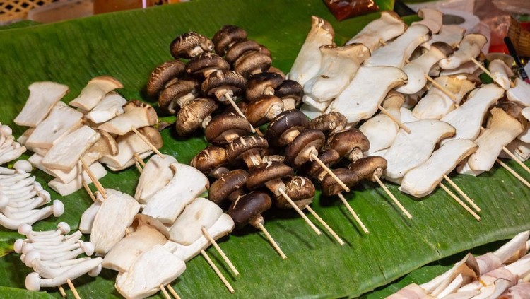 Barbecue cooking or Mala with pork, ham and mushroom on portable stove, Thailand street food.