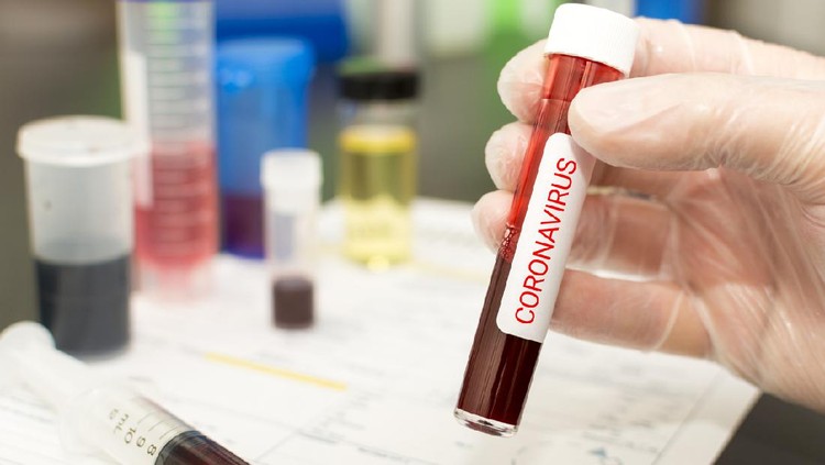 closeup of a caucasian doctor man holding a world globe with a protective mask with the word coronavirus written in it