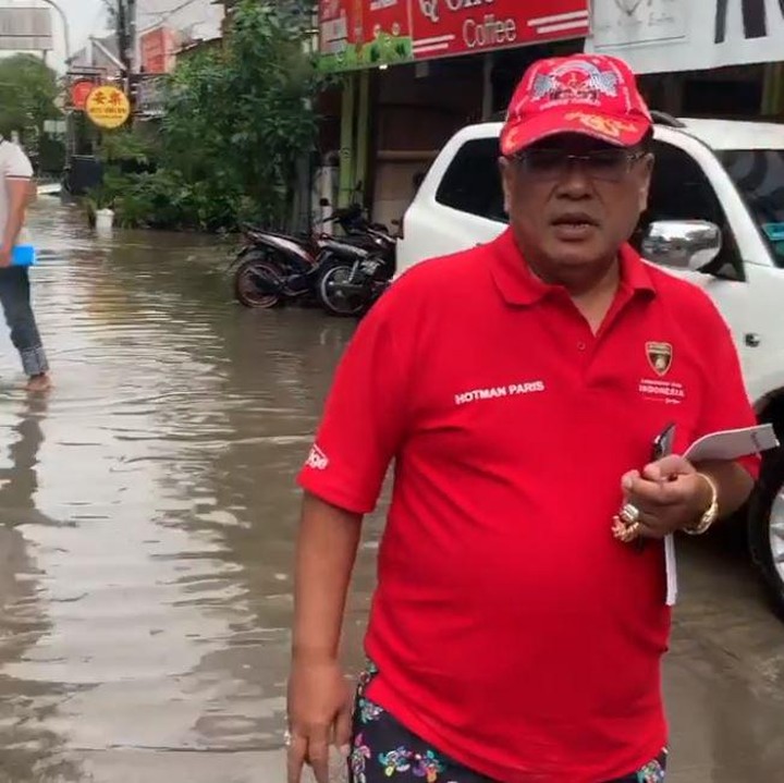 <p>Terjebak banjir, Hotman Paris terlihat berjalan kaki dengan cueknya memakai kaos dan celana pendek.</p>