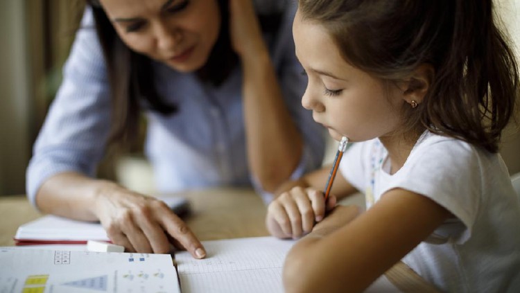 Mother helping daughter with homework