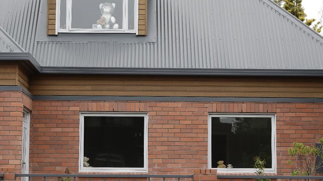 In this Sunday, March 29, 2020, photo, teddy bears sit in windows of a house in Christchurch, New Zealand. New Zealanders are embracing an international movement in which people are placing teddy bears in their windows during coronavirus lockdowns to brighten the mood and give children a game to play by spotting the bears in their neighborhoods. (AP Photo/Mark Baker)