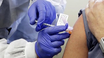 FILE - In this Monday, March 16, 2020 file photo, a patient receives a shot in the first-stage study of a potential vaccine for COVID-19, the disease caused by the new coronavirus, at the Kaiser Permanente Washington Health Research Institute in Seattle. On Friday, March 20, 2020, The Associated Press reported on stories circulating online incorrectly asserting that the first person to receive the experimental vaccine is a crisis actor. All participants who volunteered for the test were screened and had to meet a set list of criteria. They were not hired as actors to simulate a role. (AP Photo/Ted S. Warren)