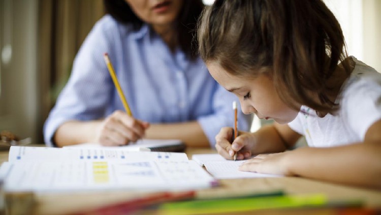 Mother helping daughters with homework