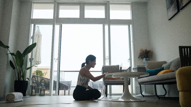 In this picture taken on March 30, 2020, YogaUP founder Chaukei Ngai greets her students as they appear on her laptop screen via the Zoom online video conferencing platform, at the start of a live streamed yoga class at her studio in Discovery Bay, on the outlying Lantau Island in Hong Kong. - More than 3.4 billion people have been called on or forced by authorities to stay at home, around 44 percent of the world population, according to a count based on an AFP database. Many are wondering how they can stay healthy during the weeks -- and possibly months -- of self-isolation that lie ahead. Hong Kongers, who live in some of the world's smallest apartments, say it can be done. (Photo by Anthony WALLACE / AFP) / TO GO WITH HongKong-health-virus-fitness,FOCUS by Jerome TAYLOR