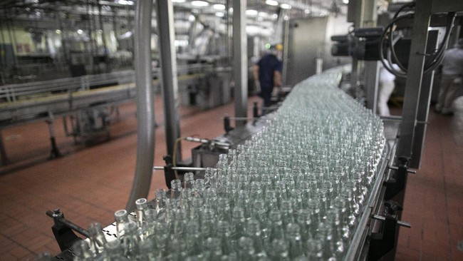 Empty bottles move along the assembly line to be filled with antiseptic alcohol at the Santa Teresa rum factory in La Victoria, Aragua state, Venezuela, Wednesday, April 1, 2020. Venezuela's premier rum distillery and one of Venezuela's few private businesses says that most of its production will be for antiseptic alcohol, in an effort to help contain the spread of the new coronavirus. (AP Photo/Ariana Cubillos)