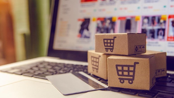 Shopping online concept - Shopping service on The online web. with payment by credit card and offers home delivery. parcel or Paper cartons with a shopping cart logo on a laptop keyboard