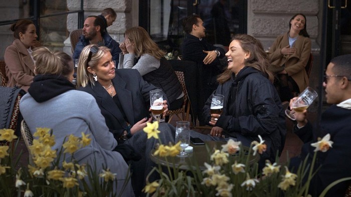 People chat and drink in Stockholm, Sweden, Wednesday, April 8, 2020. Swedish authorities have advised the public to practice social distancing because of the coronavirus pandemic, but still allow a large amount of personal freedom, unlike most other European countries. The new coronavirus causes mild or moderate symptoms for most people, but for some, especially older adults and people with existing health problems, it can cause more severe illness or death.(AP Photo/Andres Kudacki)