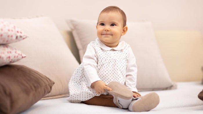 baby girl on the bed among pillows