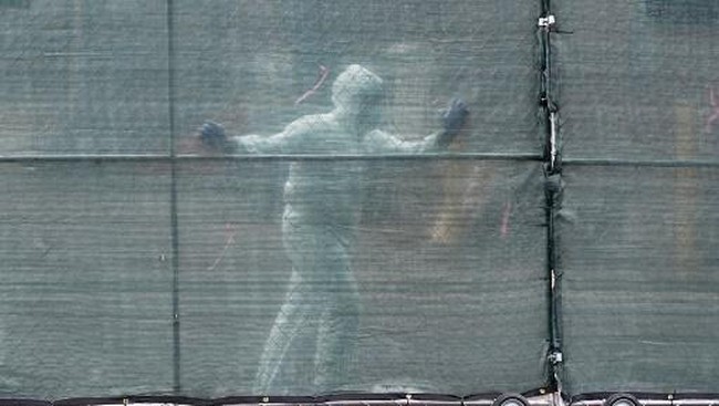 Medical personnel moves a fence in front of refrigerated trucks serving as make shift morgues at Brooklyn Hospital Center on April 09, 2020 in New York City. - America's coronavirus epicenter of New York recorded a new single-day high of 799 COVID-19 deaths Thursday but Governor Andrew Cuomo said the rate of hospitalizations continued to fall. (Photo by Angela Weiss / AFP)