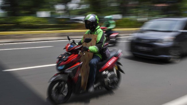 Pengemudi ojek daring membawa barang pesanan pelanggan saat melintas di kawasan Kramat Raya, Jakarta, Senin (13/4/2020). Pelaksana tugas (Plt) Menteri Perhubungan Luhut Pandjaitan mengizinkan ojek daring mengangkut penumpang selama masa Pembatasan Sosial Berskala Besar (PSBB) di Jakarta, namun dengan ketentuan harus memenuhi protokol kesehatan yang ditetapkan. ANTARA FOTO/M Risyal Hidayat/wsj.