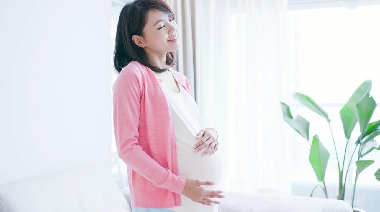 beauty pregnant woman smile and think something at home