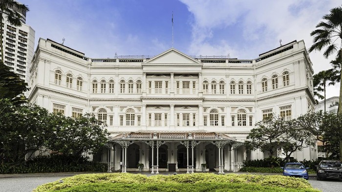 The imposing ornate Victorian facade of the 19th Century Raffles Hotel, iconic symbol of luxury and birthplace of the Singapore Sling cocktail. ProPhoto RGB profile for maximum color fidelity and gamut.