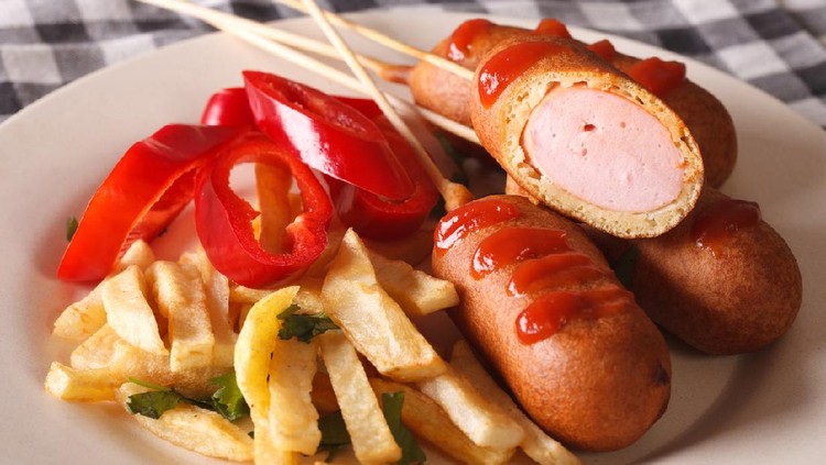 Mini Corn Dogs on stone platter with ketchup.