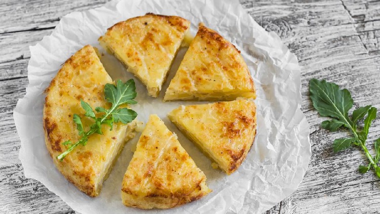 potato tortilla on a light wooden surface