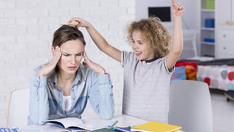 Child annoying his tired mother with headache