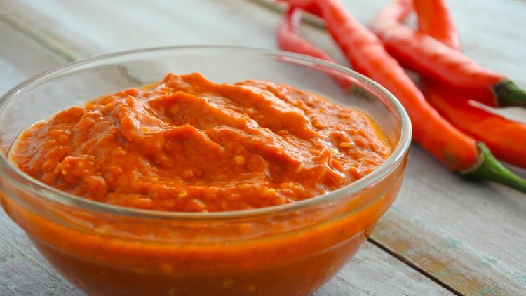 Composition with tasty chili sauce on grey textured table