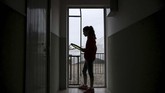 Bermain Tenis di Atap Rumah di Tengah Lockdown Covid-19 Carola Pessina is silouhetted before playing tennis with Vittoria Oliveri (unseen) on the rooftops of their house in Finale Ligure, Liguria Region, northwestern Italy on April 19, 2020, during the country's lockdown aimed at stopping the spread of the COVID-19 (new coronavirus) pandemic. - Everyday Carola Pessina, 11, and Vittoria Oliveri, 13, play tennis from a rooftop to another rooftop of their homes to practice during the Covid 19 lockdown. (Photo by MARCO BERTORELLO / AFP)