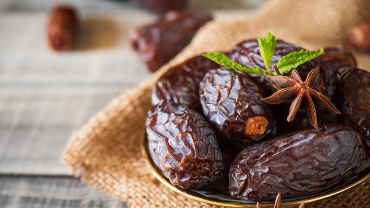 Ramadan dates or kurma for iftar in a box. Isolated on black, studio shot.
