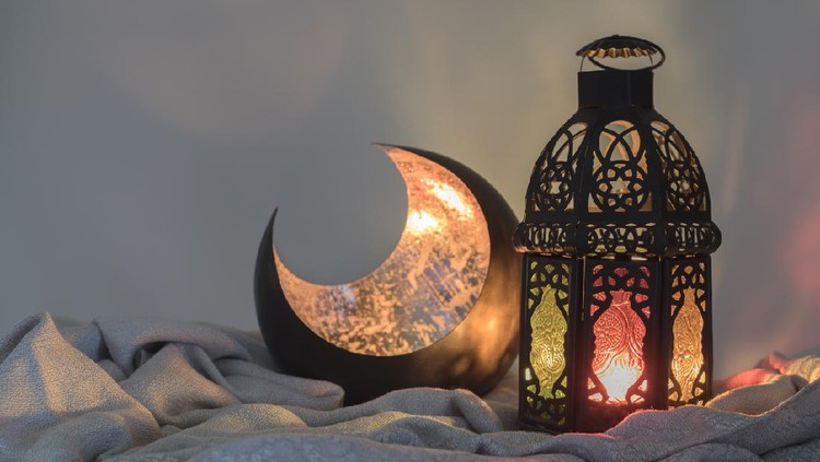 Lantern and a copper crescent shape on a satin cloth
