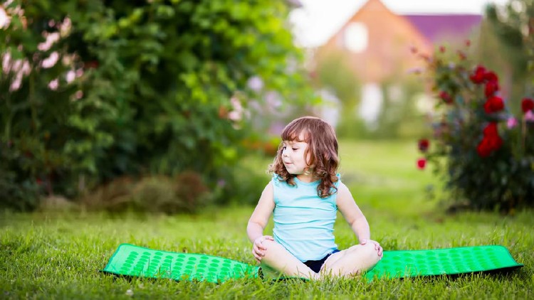 Kid doing fitness exercises outdoors at summer day. Yoga for kids, active healthy life. Fitness. Sport for little children.
