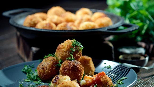 Eating homemade potato croquettes