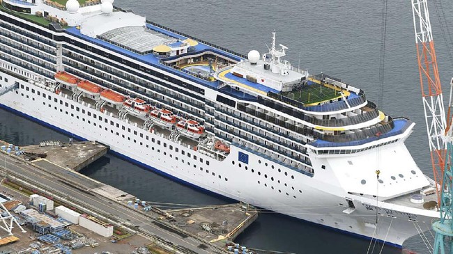 In this April 21, 2020, photo, Italian-operated cruise ship the Costa Atlantica is anchored at a port in Nagasaki, southern Japan. 
Japanese officials said a few dozens of crew members on the cruise ship docked have tested positive for the coronavirus on Wednesday, the day after a first case from the ship was reported. (Kyodo News via AP)