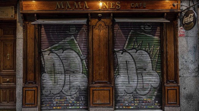 In this Monday, April 20, 2020 photo, detail of the entrance of a cafe closed during the coronavirus outbreak in Madrid, Spain. The Spanish Trade Confederation, which represents thousands of small businesses, says up to 30% of them nationwide will close their doors forever unless they get government financial help. (AP Photo/Bernat Armangue)